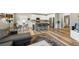 Open-concept living space with kitchen island, dining area, and living room seamlessly connected at 4500 Copeland Cir # 104, Highlands Ranch, CO 80126