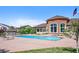 Outdoor swimming pool surrounded by lounge chairs, mature trees, and a clubhouse under a bright sky at 4500 Copeland Cir # 104, Highlands Ranch, CO 80126