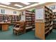 Reading room with bookshelves full of reading materials, a table, and a comfortable chair at 300 S Clinton St # 11B, Denver, CO 80247