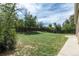 Large backyard offers ample green space with a wooden fence, perfect for relaxation and outdoor enjoyment at 2120 S Ouray St, Aurora, CO 80013