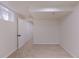 Unfurnished basement room featuring neutral carpet and white walls leading to an open doorway at 2120 S Ouray St, Aurora, CO 80013