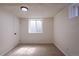 Unfurnished basement room with neutral carpet, a window, and a simple overhead light fixture at 2120 S Ouray St, Aurora, CO 80013