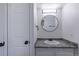 Updated bathroom featuring granite countertop and round mirror with a modern vanity at 2120 S Ouray St, Aurora, CO 80013
