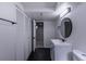 Bathroom with black tile floors and a row of white closet doors running the length of the wall at 2120 S Ouray St, Aurora, CO 80013