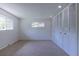 Bedroom featuring neutral carpet, ample natural light, and a closet with louvered doors at 2120 S Ouray St, Aurora, CO 80013
