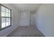 Bedroom featuring neutral carpet, natural light, and a closet with bifold doors at 2120 S Ouray St, Aurora, CO 80013