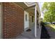 Close-up of the home's entrance featuring a decorative front door, brick accents, and covered porch at 2120 S Ouray St, Aurora, CO 80013