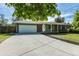 Well-kept single-story home with a large driveway, attached garage, and lush green lawn at 2120 S Ouray St, Aurora, CO 80013