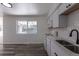 Modern kitchen featuring white cabinets, stainless steel appliances, and a view of the backyard at 2120 S Ouray St, Aurora, CO 80013