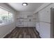 Bright kitchen boasts white cabinetry, modern appliances, hardwood floors, and natural light at 2120 S Ouray St, Aurora, CO 80013