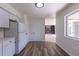 Light and airy kitchen with wood-look flooring, white cabinets, and a pantry for easy storage and organization at 2120 S Ouray St, Aurora, CO 80013