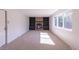 Living room with brick fireplace, built-in shelves, and natural light from large windows at 2120 S Ouray St, Aurora, CO 80013