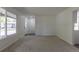 Inviting living room features carpet, white walls, and a glimpse of the front exterior at 2120 S Ouray St, Aurora, CO 80013