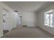 Bright living room with neutral carpet, white walls, and a large window for ample natural light at 2120 S Ouray St, Aurora, CO 80013
