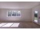 Bright living room with a large window offering a view of the outdoors and natural light at 2120 S Ouray St, Aurora, CO 80013