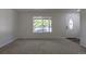 Spacious living room features neutral carpet, white walls, and a view of the front yard at 2120 S Ouray St, Aurora, CO 80013