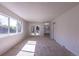 Spacious living room featuring a sliding glass door, large window, and view into the kitchen at 2120 S Ouray St, Aurora, CO 80013