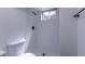 Bright shower with a small window, rainfall shower head and white tiling at 2120 S Ouray St, Aurora, CO 80013