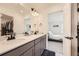Elegant bathroom featuring a double vanity, modern fixtures, and a doorway to the bedroom at 10136 Worchester St, Commerce City, CO 80022