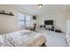 Inviting bedroom with a large window, a tray ceiling, and carpeted floors at 10136 Worchester St, Commerce City, CO 80022