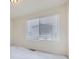 Bright bedroom featuring white walls and carpet, with a large window providing natural light at 10136 Worchester St, Commerce City, CO 80022