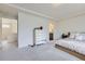 Spacious carpeted bedroom features a walk-in closet and leads to an en-suite bathroom at 10136 Worchester St, Commerce City, CO 80022