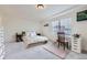 Bright bedroom with a large window, a tray ceiling, and carpeted floors creates a cozy retreat at 10136 Worchester St, Commerce City, CO 80022