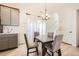 Cozy dining area featuring a modern light fixture, table with four chairs, and adjacent kitchen at 10136 Worchester St, Commerce City, CO 80022