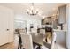 Bright and airy dining area blending into the living room and showcasing the adjacent kitchen at 10136 Worchester St, Commerce City, CO 80022