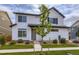 Inviting two-story home with white siding, black trim, a young tree, and well-manicured lawn at 10136 Worchester St, Commerce City, CO 80022