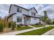 Charming two-story home featuring white siding, black accents, and a well-maintained front yard at 10136 Worchester St, Commerce City, CO 80022