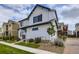 Beautifully-sited two-story home showcasing white siding, manicured landscaping, and a welcoming entrance at 10136 Worchester St, Commerce City, CO 80022