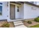 Close-up of the home's entrance, featuring a welcoming front porch and tasteful landscaping at 10136 Worchester St, Commerce City, CO 80022