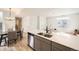 Modern kitchen features stainless steel appliances, light wood floors, and an island with a sink at 10136 Worchester St, Commerce City, CO 80022