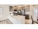 Stylish kitchen boasting gray cabinets, quartz countertops, stainless steel appliances, and an island at 10136 Worchester St, Commerce City, CO 80022