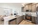 Modern kitchen featuring stainless steel appliances, gray cabinets, and an open layout at 10136 Worchester St, Commerce City, CO 80022