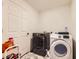 Clean laundry room with a modern front-load washer and dryer on an attractive marble-patterned floor at 10136 Worchester St, Commerce City, CO 80022
