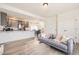 Open-concept living space with gray sofa flowing seamlessly into a kitchen and dining area at 10136 Worchester St, Commerce City, CO 80022