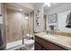 Updated bathroom features a tiled shower with glass doors, granite countertop vanity, and neutral decor at 14049 Detroit Dr, Thornton, CO 80602