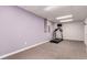 A finished basement area with neutral carpet, a window, and a treadmill with a television monitor at 10720 Moore Cir, Westminster, CO 80021