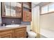 Bathroom featuring wood cabinets and fixtures, with a combined tub and shower at 10720 Moore Cir, Westminster, CO 80021