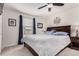A cozy bedroom with a wood-frame bed, soft carpet, and a ceiling fan at 10720 Moore Cir, Westminster, CO 80021