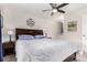 Comfortable bedroom featuring a wood-frame bed, bedside tables, and a ceiling fan at 10720 Moore Cir, Westminster, CO 80021