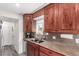 Functional kitchen featuring dark wood cabinets, a stainless steel sink, and granite countertops at 10720 Moore Cir, Westminster, CO 80021