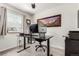 A clean office with a modern computer set-up and a framed mountain landscape print at 10720 Moore Cir, Westminster, CO 80021