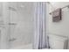 A bright shower with white tiles and glass shelves at 10720 Moore Cir, Westminster, CO 80021