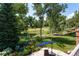 Beautiful backyard with green lawn, flower beds, and patio with a large umbrella at 6722 S Wolff Ct, Littleton, CO 80128