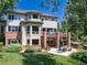 Expansive backyard with mature trees, patio, and outdoor seating area at 6722 S Wolff Ct, Littleton, CO 80128