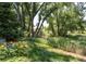 Lush backyard featuring mature trees and well-maintained landscaping at 6722 S Wolff Ct, Littleton, CO 80128