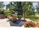 Relaxing backyard patio with seating area, mature trees, and professional landscaping at 6722 S Wolff Ct, Littleton, CO 80128